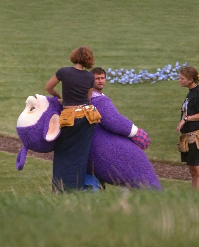Behind the scenes shot of a purple Teletubbies costume, a weird and funny photo.