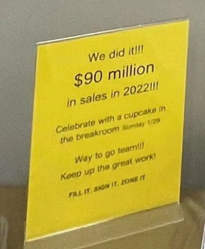 Yellow workplace sign celebrating sales, a funny example of random photos capturing corporate culture funny moments