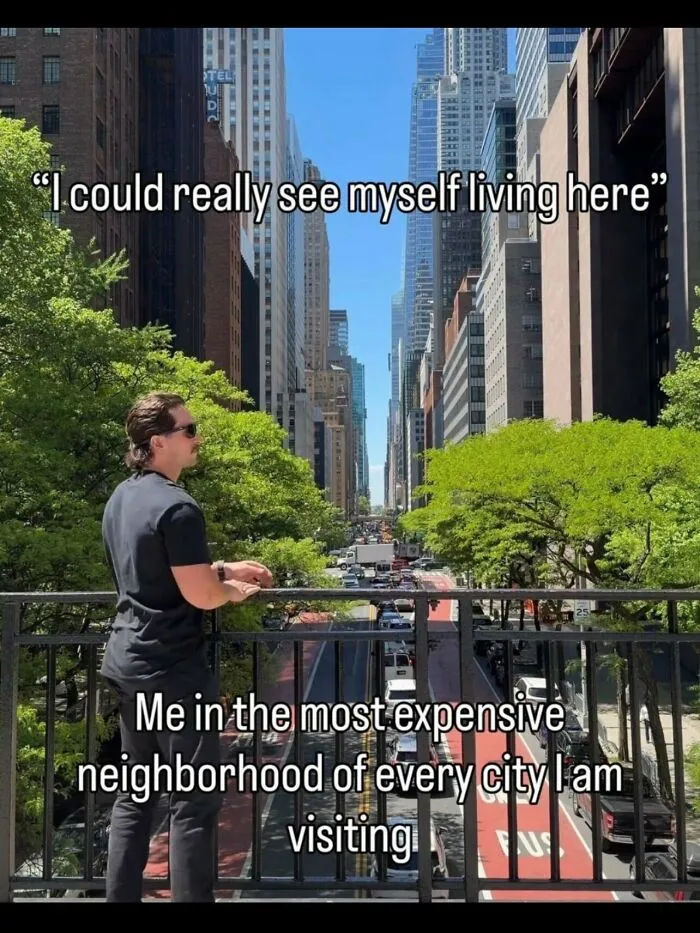 A man looking over a balcony at a city street in a funny meme about expensive neighborhoods.