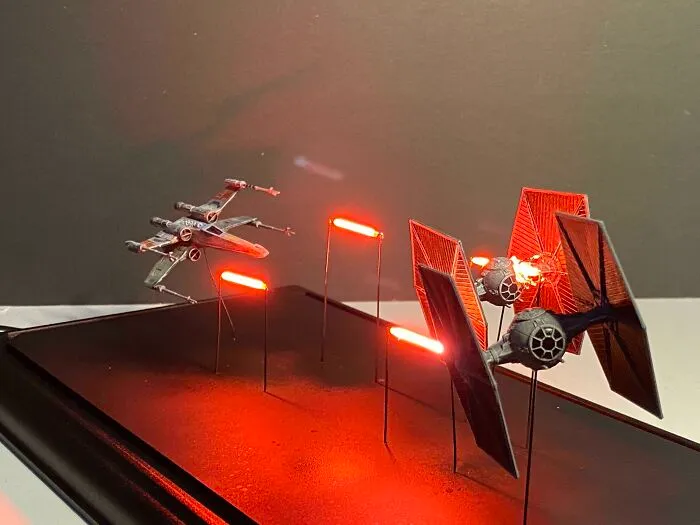 Star Wars miniature models with LED laser effects in a space battle scene