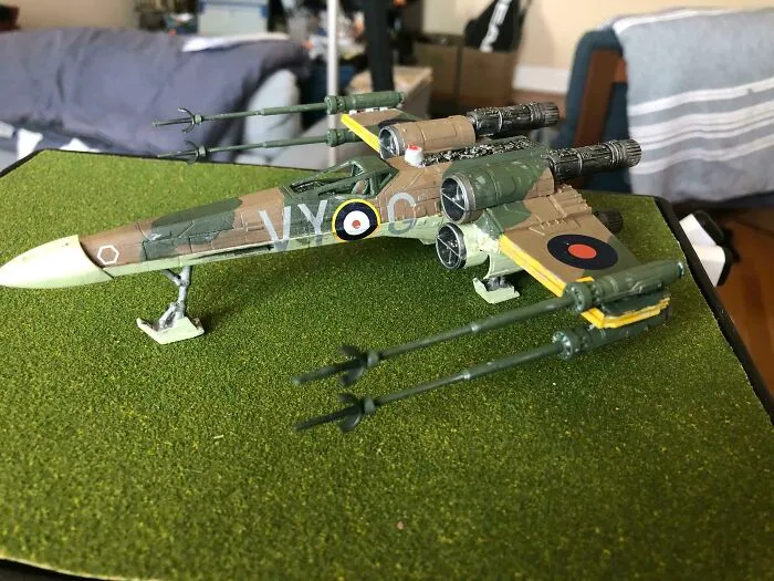 Detailed miniature model of a sci-fi fighter plane on grass base