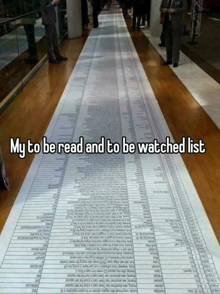Long to be read and watched list stretching across floor at event