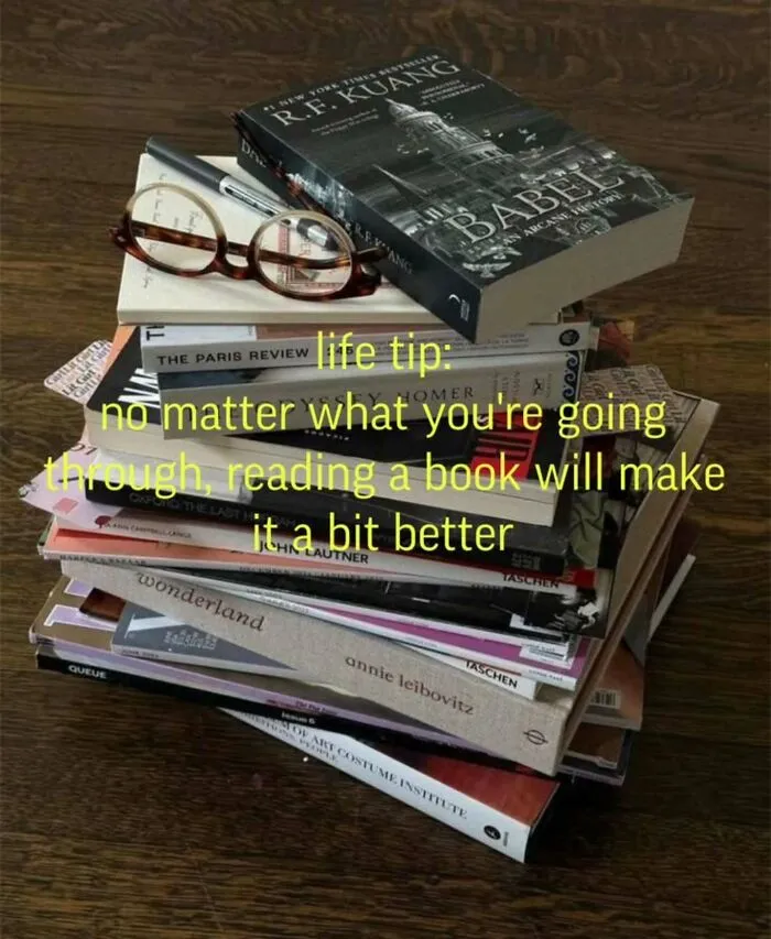 Stack of books with glasses and reading life tip text