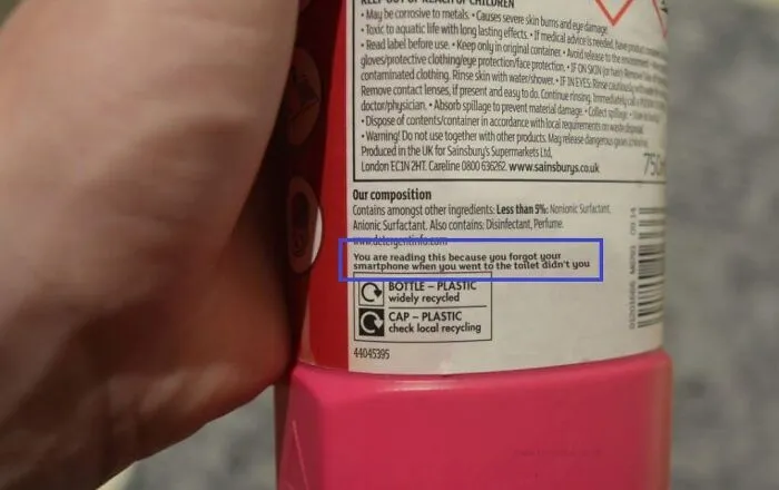 Cleaning product bottle with humorous and confusing labels and instructions about forgetting a smartphone.