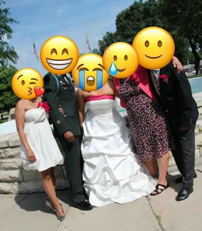 Wedding guests posing with bride and groom wearing white and military outfit
