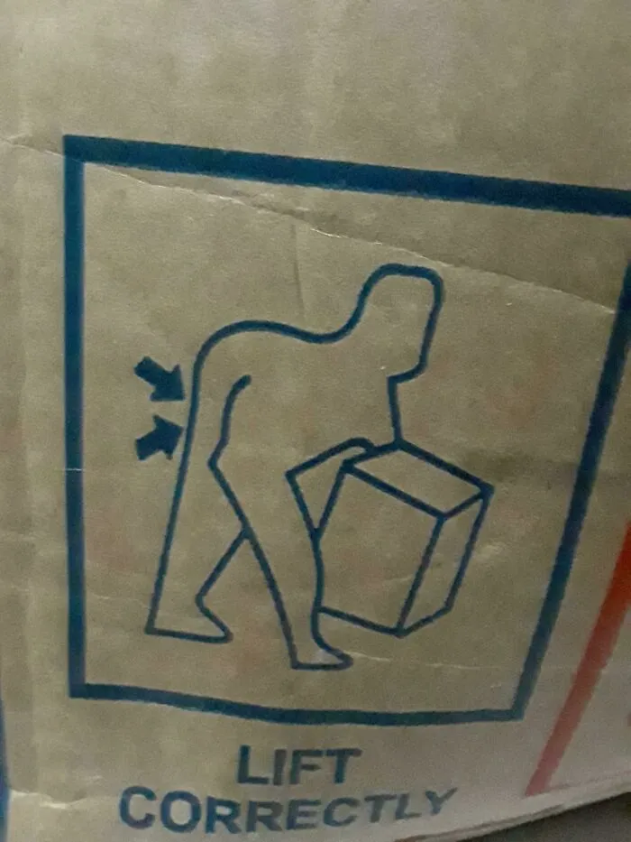 A confusing label on a box depicting a person bending over awkwardly with the text Lift Correctly.