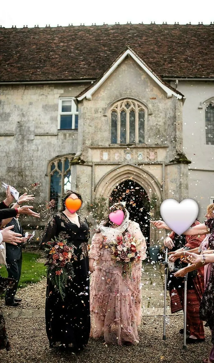 Wedding couple exits venue while guests throw confetti outdoors