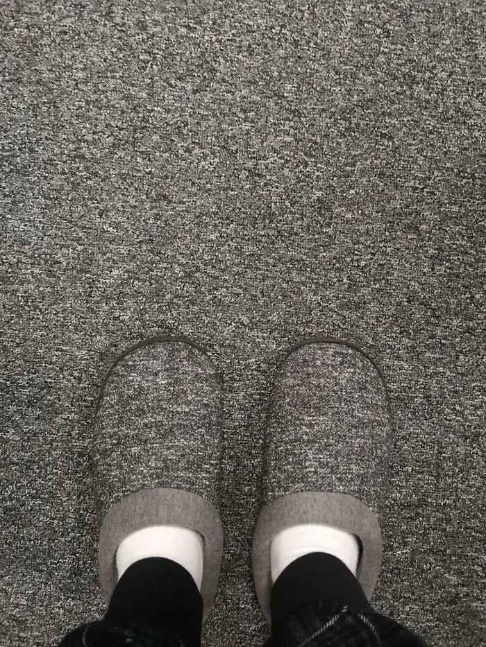 Person wearing slippers blending into matching carpet matrix glitch
