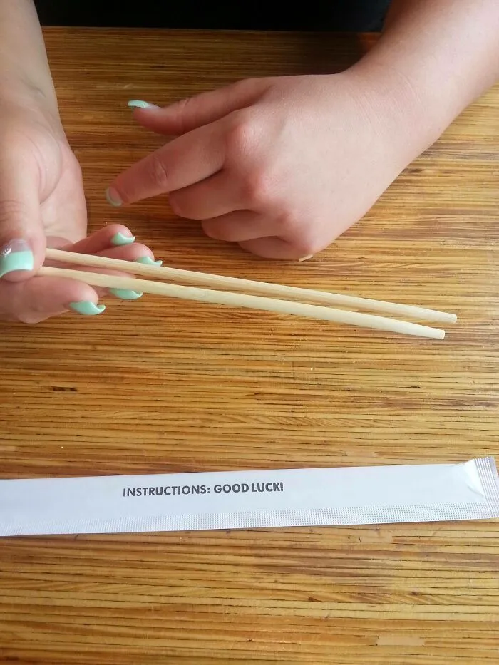 Chopstick wrapper with confusing instructions that say Good Luck!
