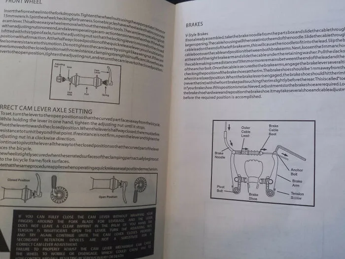 A dense wall of text with bicycle diagrams demonstrating confusing instructions for front wheel and brake settings.