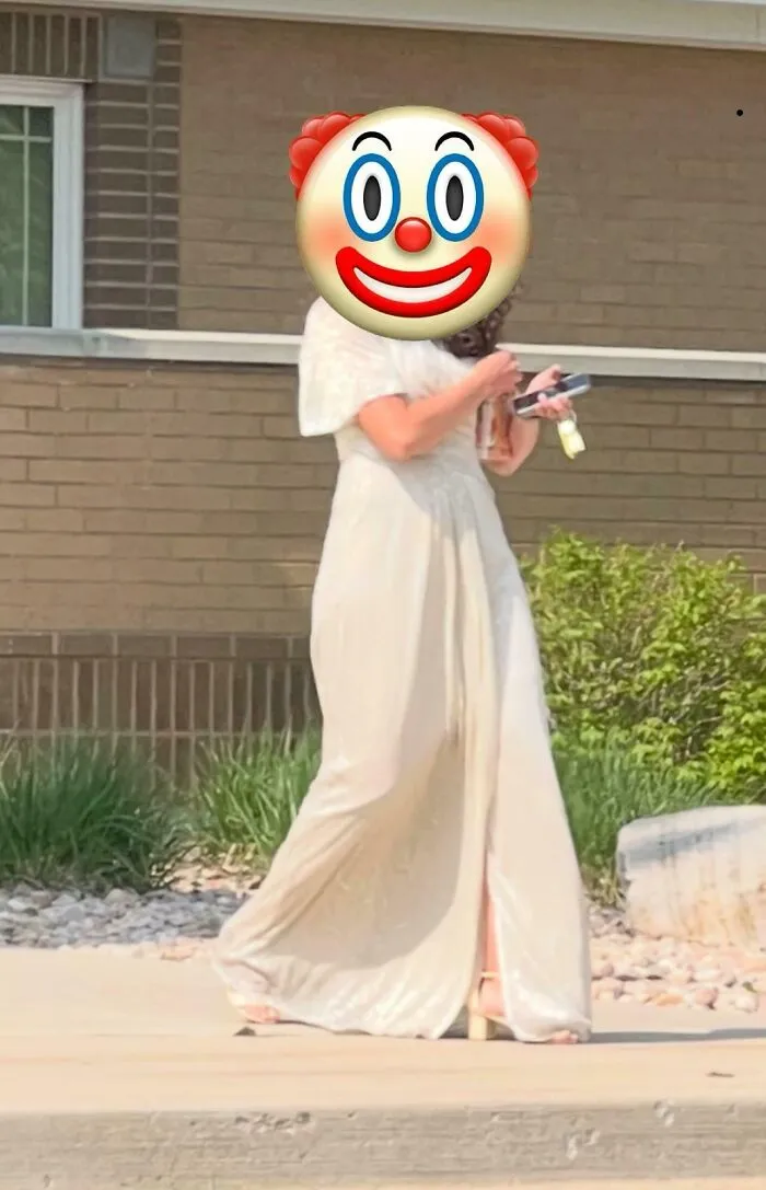 Wedding guest wearing a white dress with slit walking outside