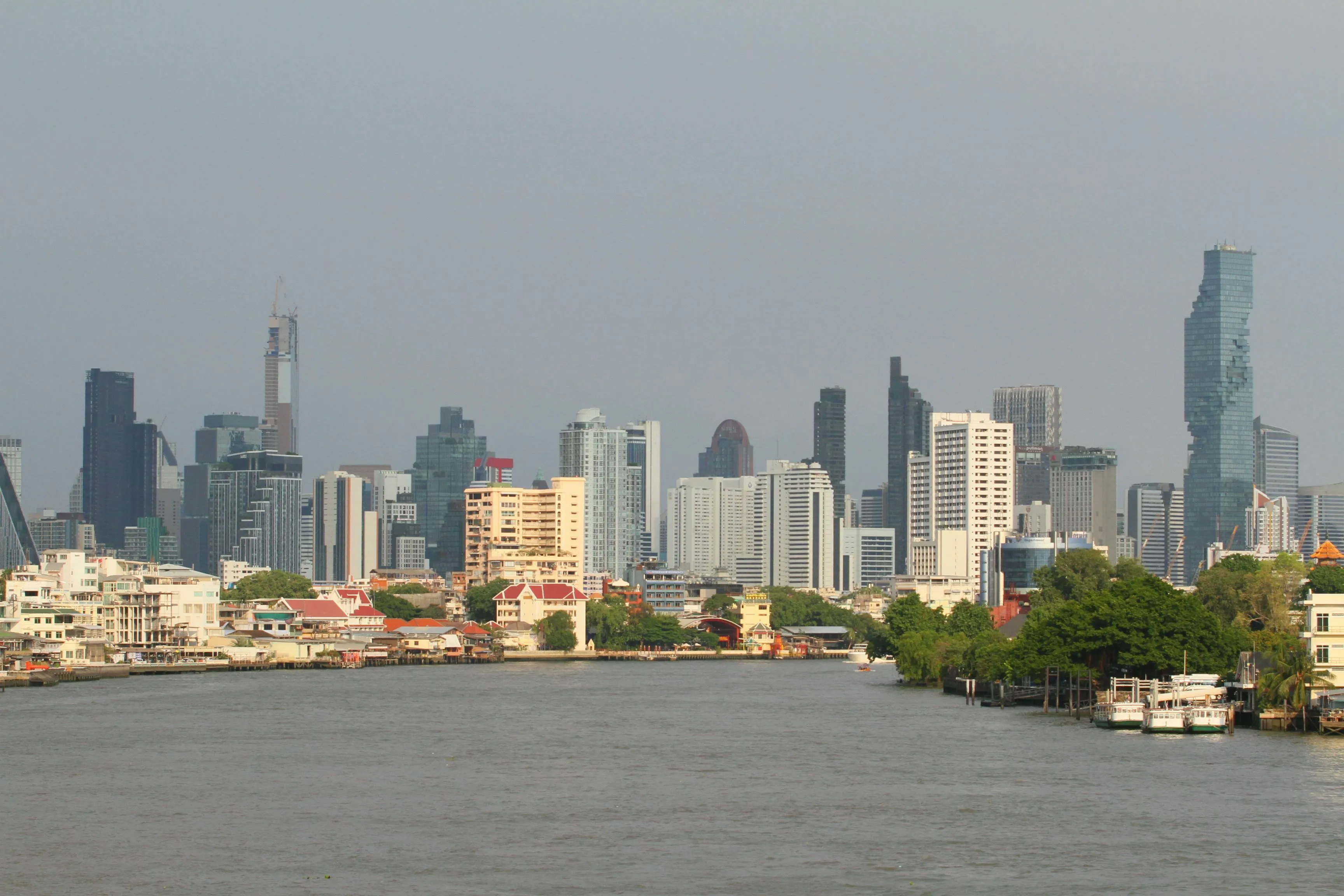 Bangkok city skyline along the Chao Phraya River with modern buildings and waterway