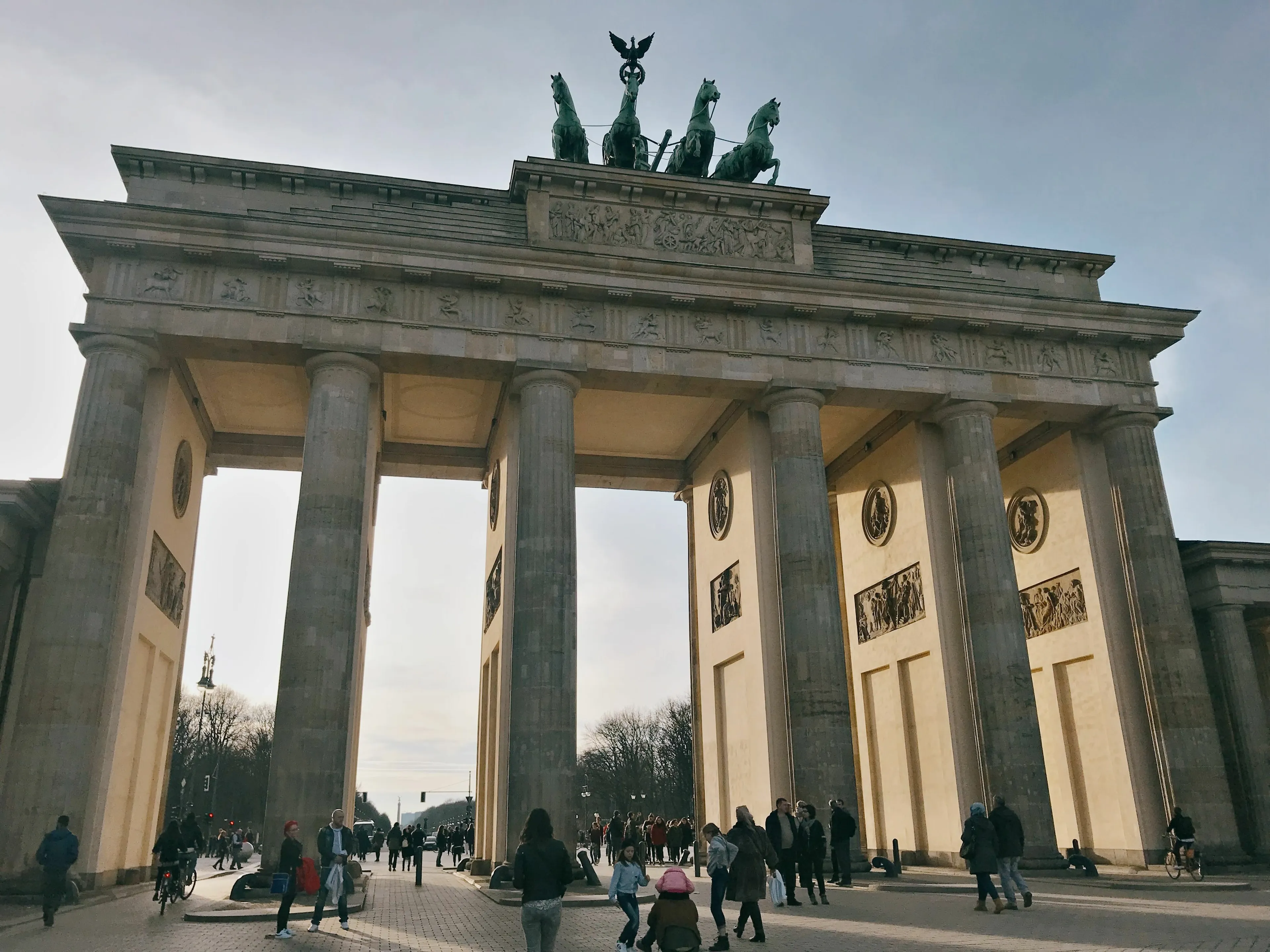 Brandenburg Gate in Berlin with crowds and clear sky