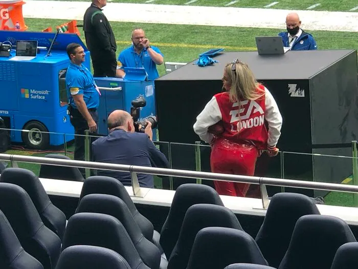 Woman in red pants posing as influencers film photos in public spaces.
