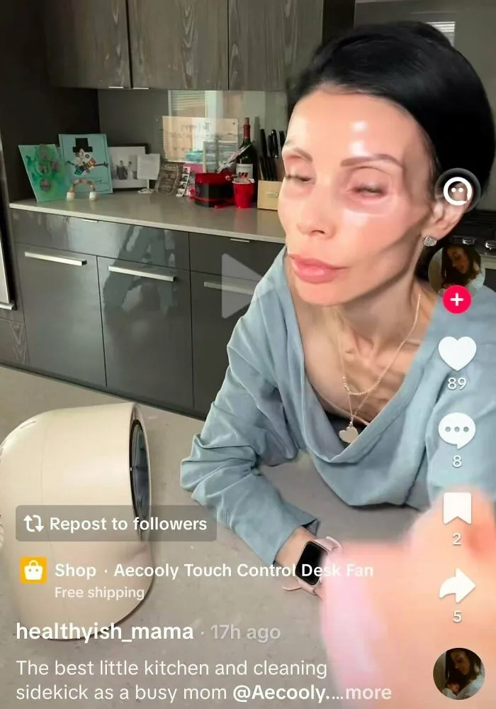 Influencers filming a product promo video using a desk fan inside a modern kitchen content studio