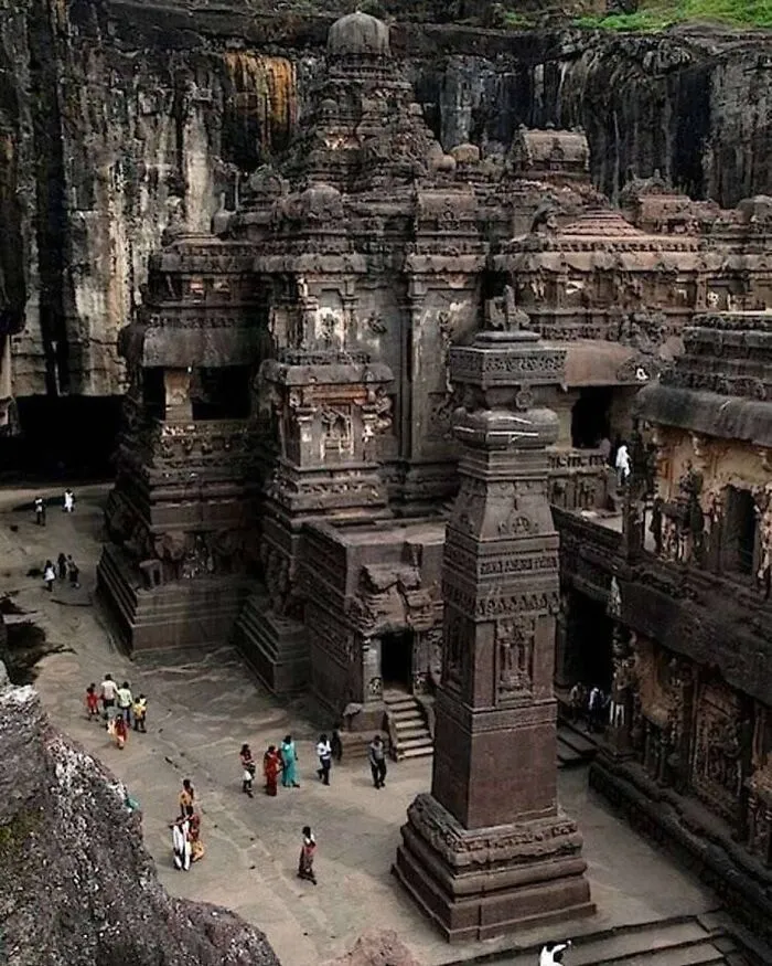 Massive ancient rock-cut temple carved from a mountain showing cool history facts.