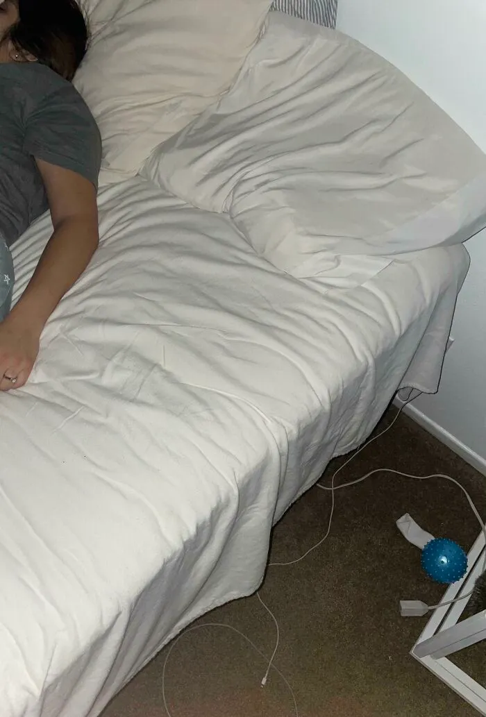 A person lying diagonally across a bed, taking up all the space.