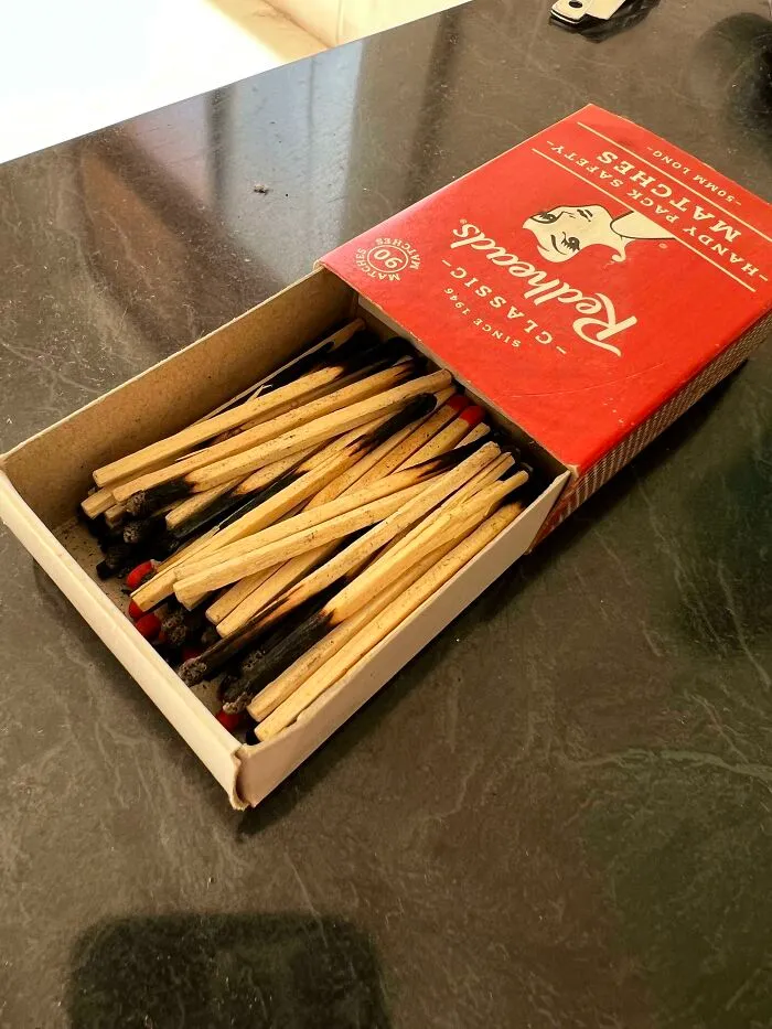An open box of Redheads safety matches containing burnt matchsticks, illustrating things partners do.