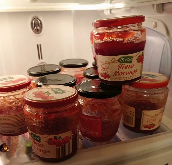 Multiple jars of strawberry jam inside a refrigerator, showing frustrating things partners do.