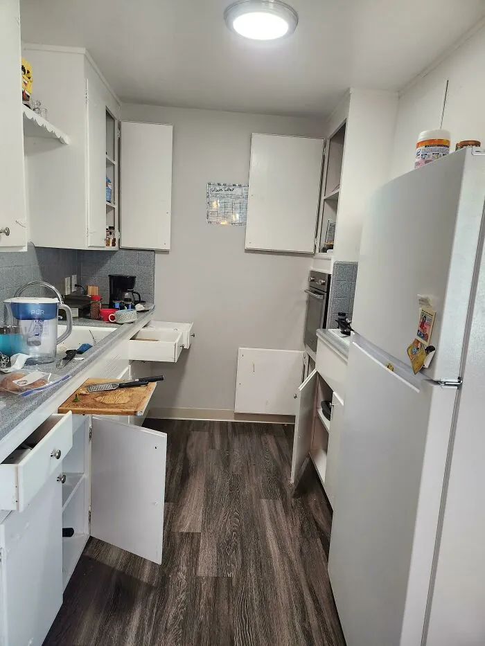 Messy kitchen with open cabinet doors and drawers illustrating things partners do that drive people insane.