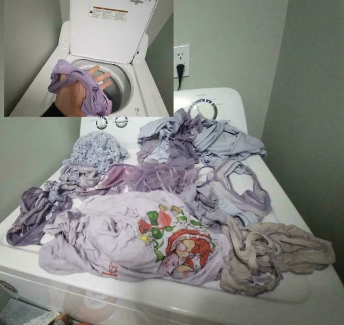 Pile of light purple laundry left on top of a washing machine by partners driving people insane.