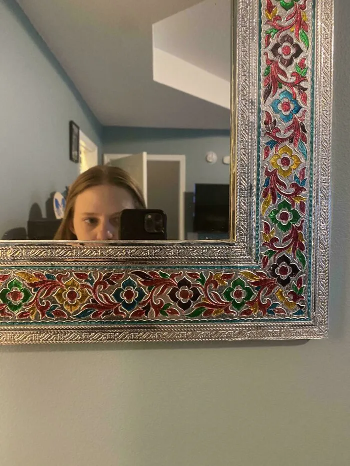 Woman reflected at the bottom of a tall decorative mirror highlighting annoying things partners do