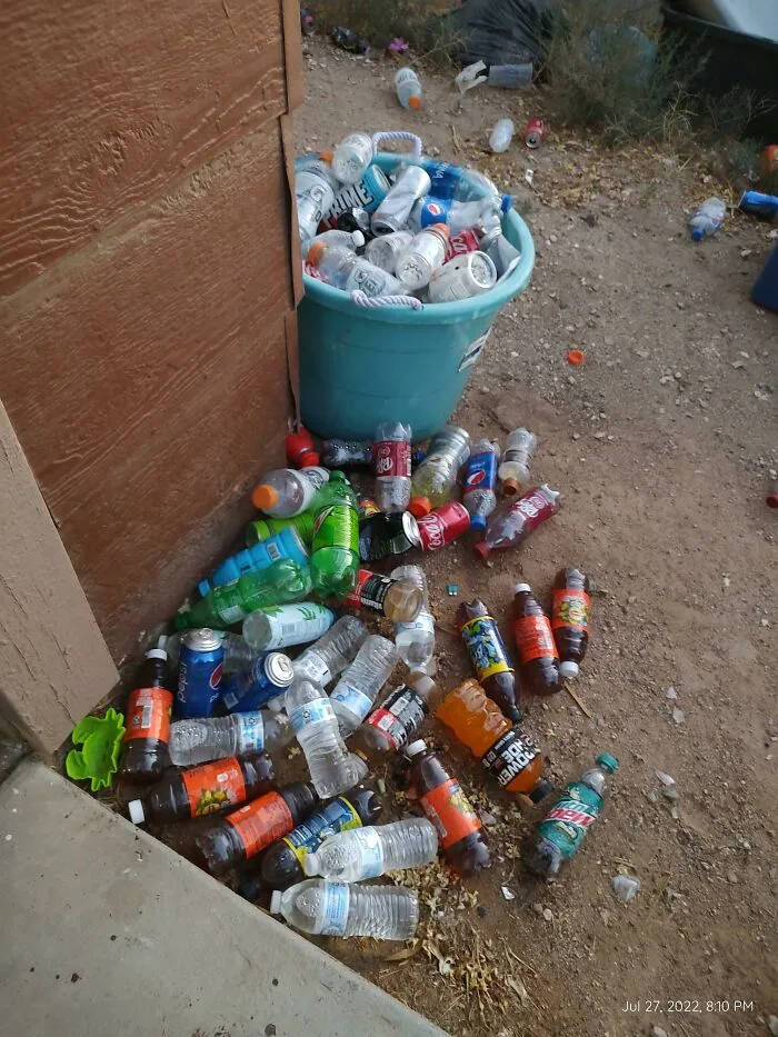 A huge pile of empty plastic bottles on the ground showing weird things partners do