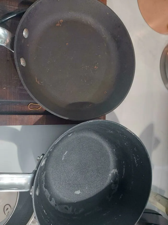 Scratched non-stick frying pan and saucepan with worn coating, showcasing frustrating habits of partners