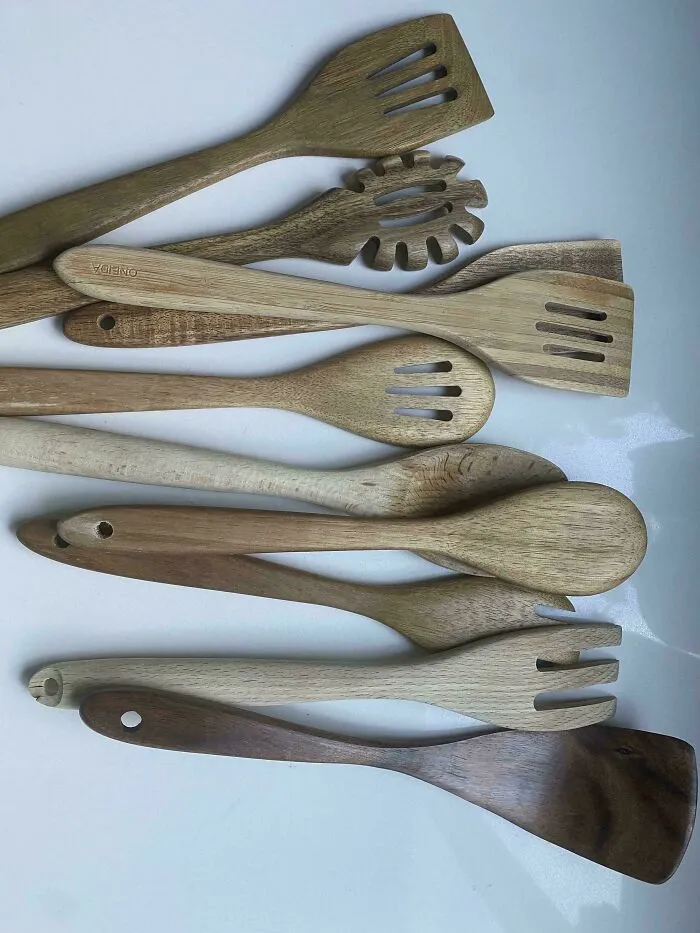 A mess of wooden kitchen utensils piled together that drive partners insane.