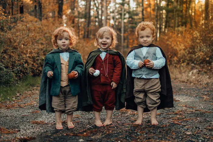 Three young kids wearing Hobbit Halloween costumes in woods
