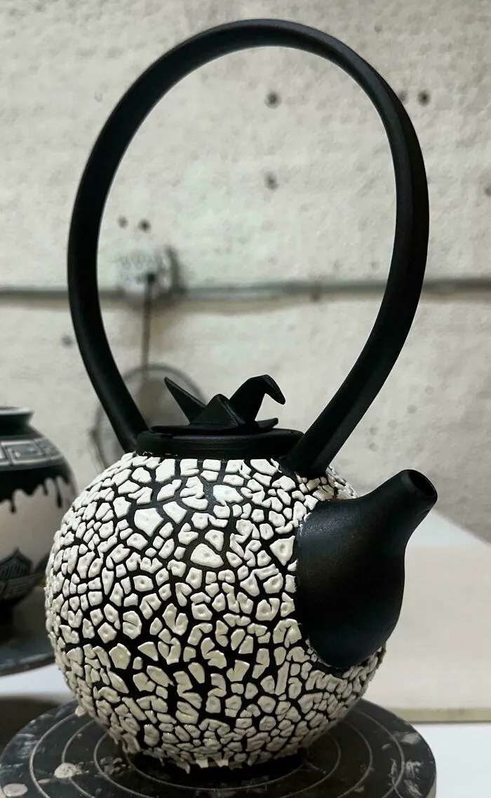 A unique black and white textured teapot as part of creative pottery creations