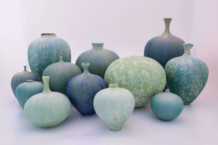 A collection of blue and green textured vases showcasing handmade pottery creations