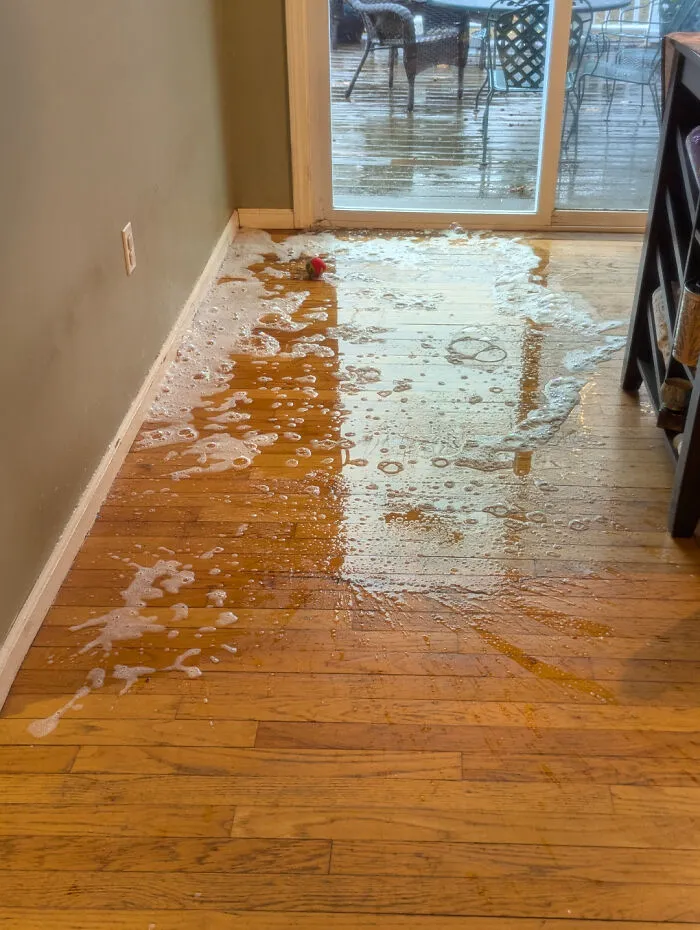 Foamy soap spill covering a wooden floor, driving partners insane