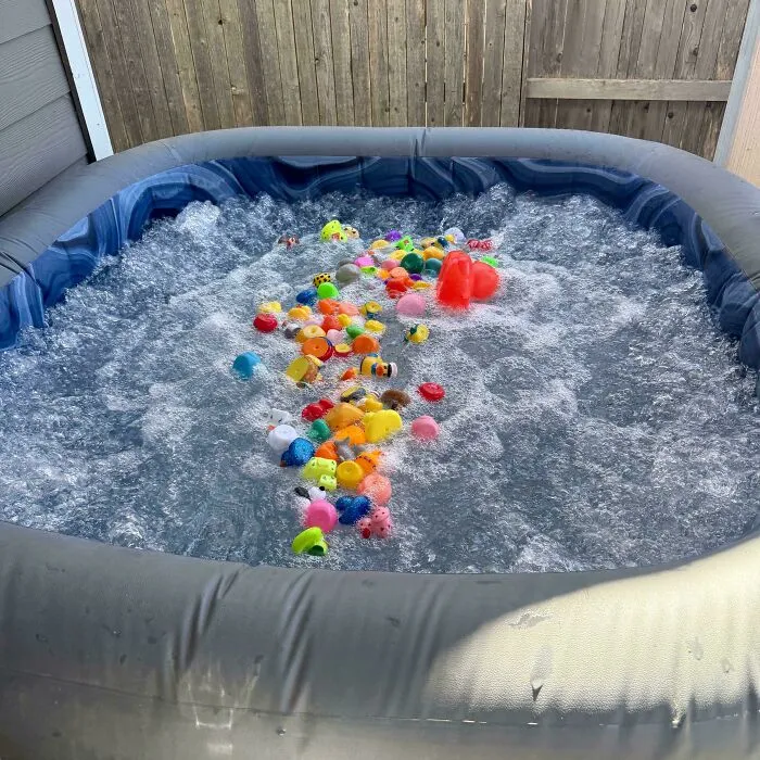 Hot tub filled with colorful plastic toys, illustrating crazy things partners do.