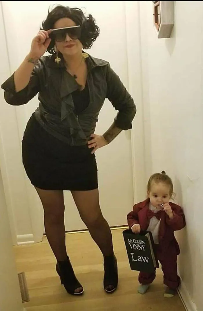 A woman and toddler dressed in My Cousin Vinny themed Halloween costumes.
