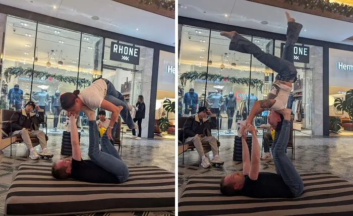 Influencers practicing acroyoga stunts in a public mall concourse area.
