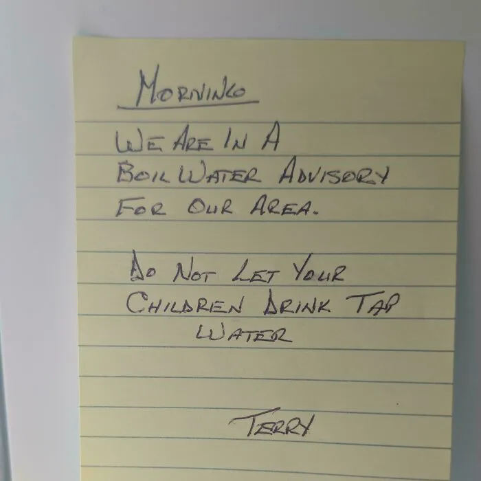 Handwritten note warning about boil water advisory, representing wholesome moments.