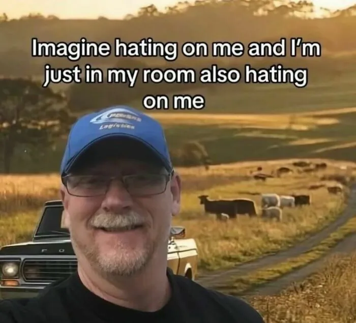 A relatable meme of a man smiling with text about hating on oneself in their room.