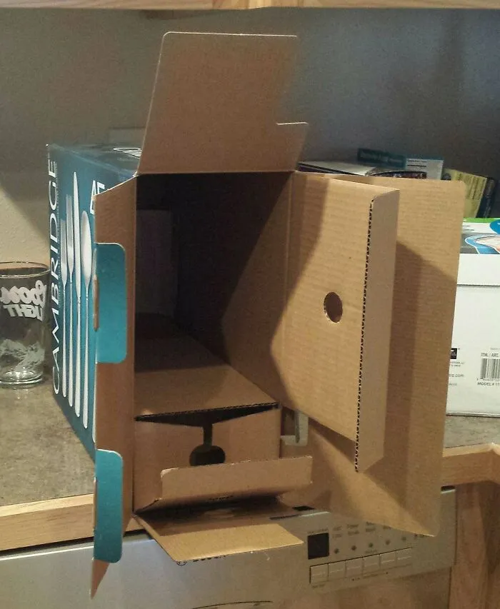 Open cutlery box showcasing bad packaging fails with excessive empty cardboard space inside.