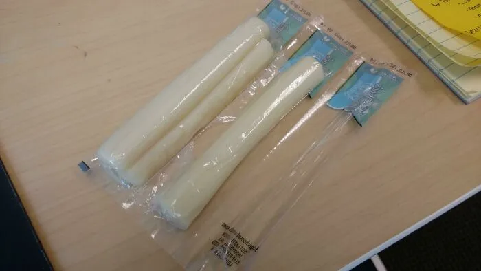 Two cheese sticks sealed together inside a single wrapper, showing bad packaging fails.