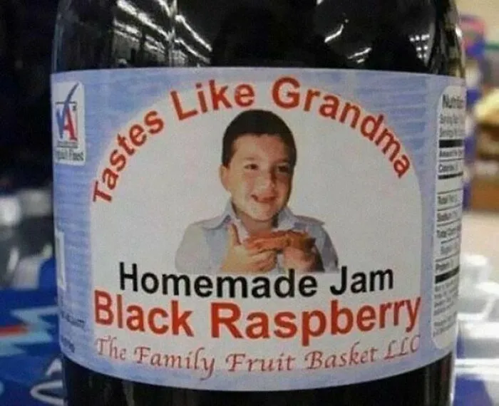A jar of black raspberry jam featuring an awkward packaging fail quote that says Tastes Like Grandma
