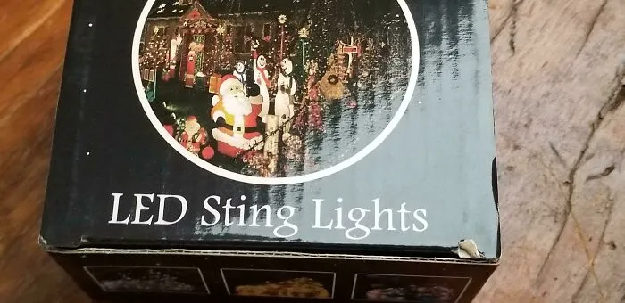 A box for Christmas decorations featuring a funny packaging fail label that reads LED Sting Lights