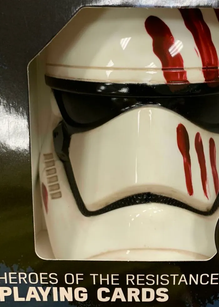 Close-up of a mask toy inside a box, showing bad packaging design.