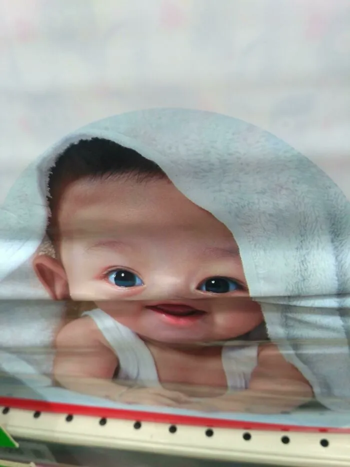 Misaligned baby picture print on product wrap showcasing funny packaging fails.
