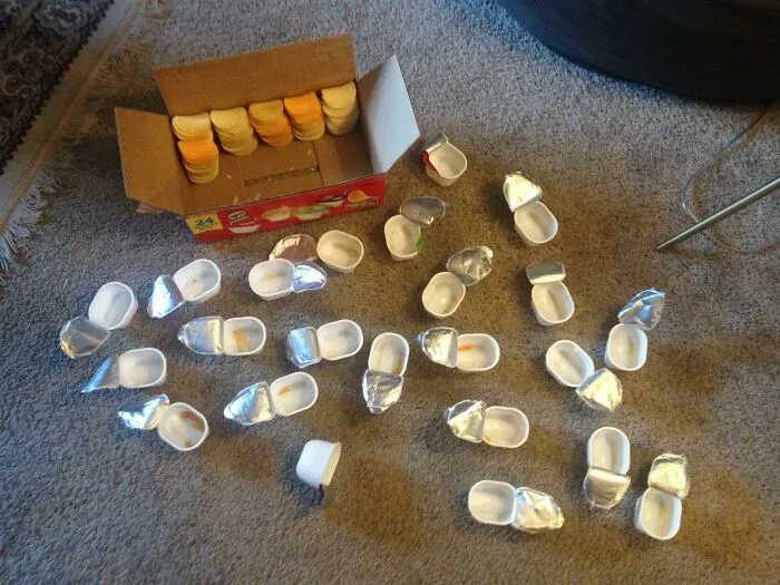 Excessive plastic containers spilled out of cardboard box displaying packaging fails