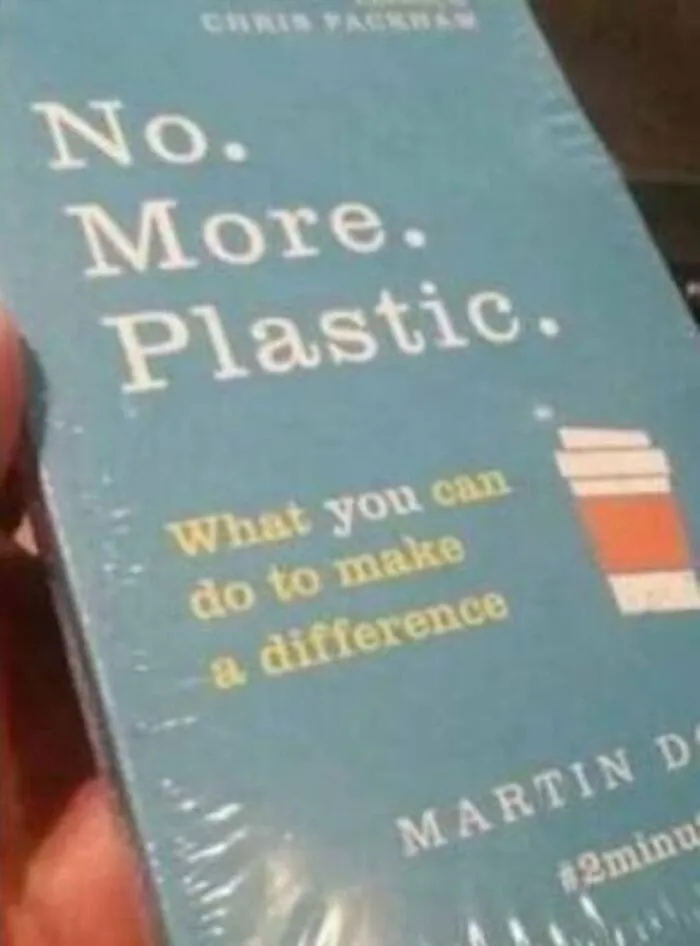 Book titled No More Plastic wrapped in plastic film as an ironic bad packaging fail.