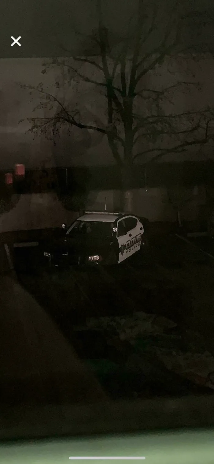 Dark street view of a police car, captured in photos for the last time.
