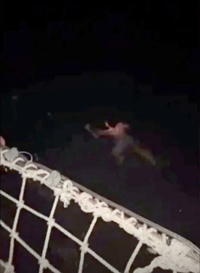 Blurry figure near a safety net captured in photos for the last time at night