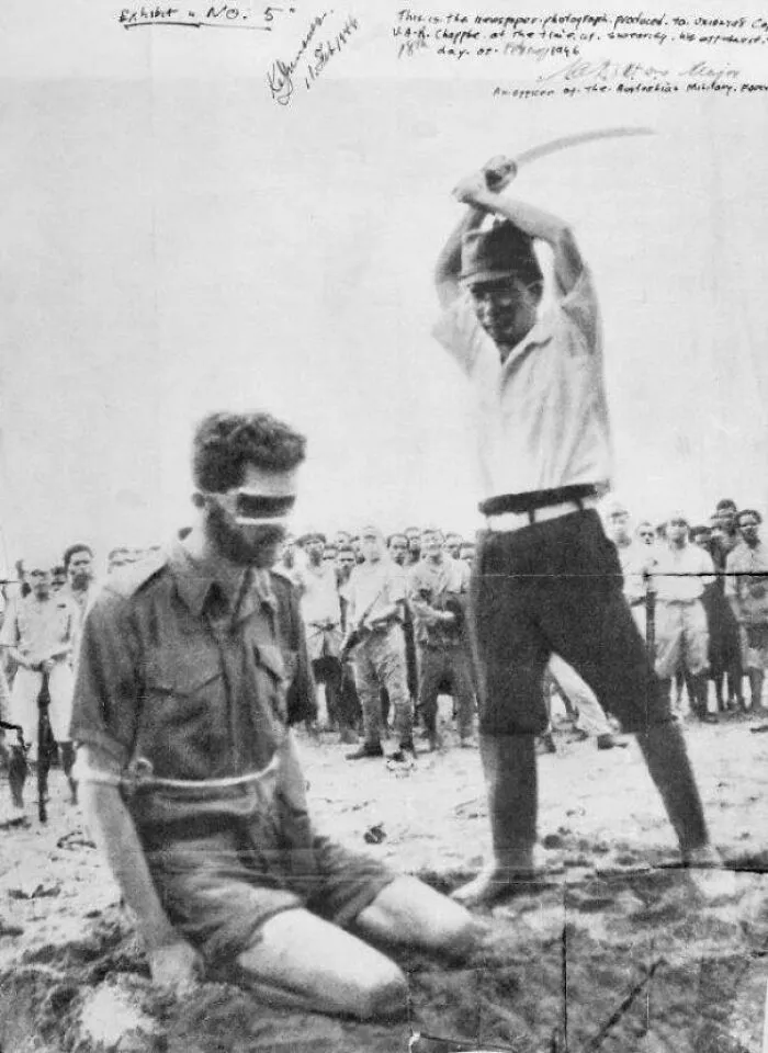 Historical photo of a blindfolded prisoner captured in photos for the last time before execution
