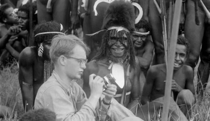 A photographer sitting with indigenous tribespeople, captured in photos for the last time.